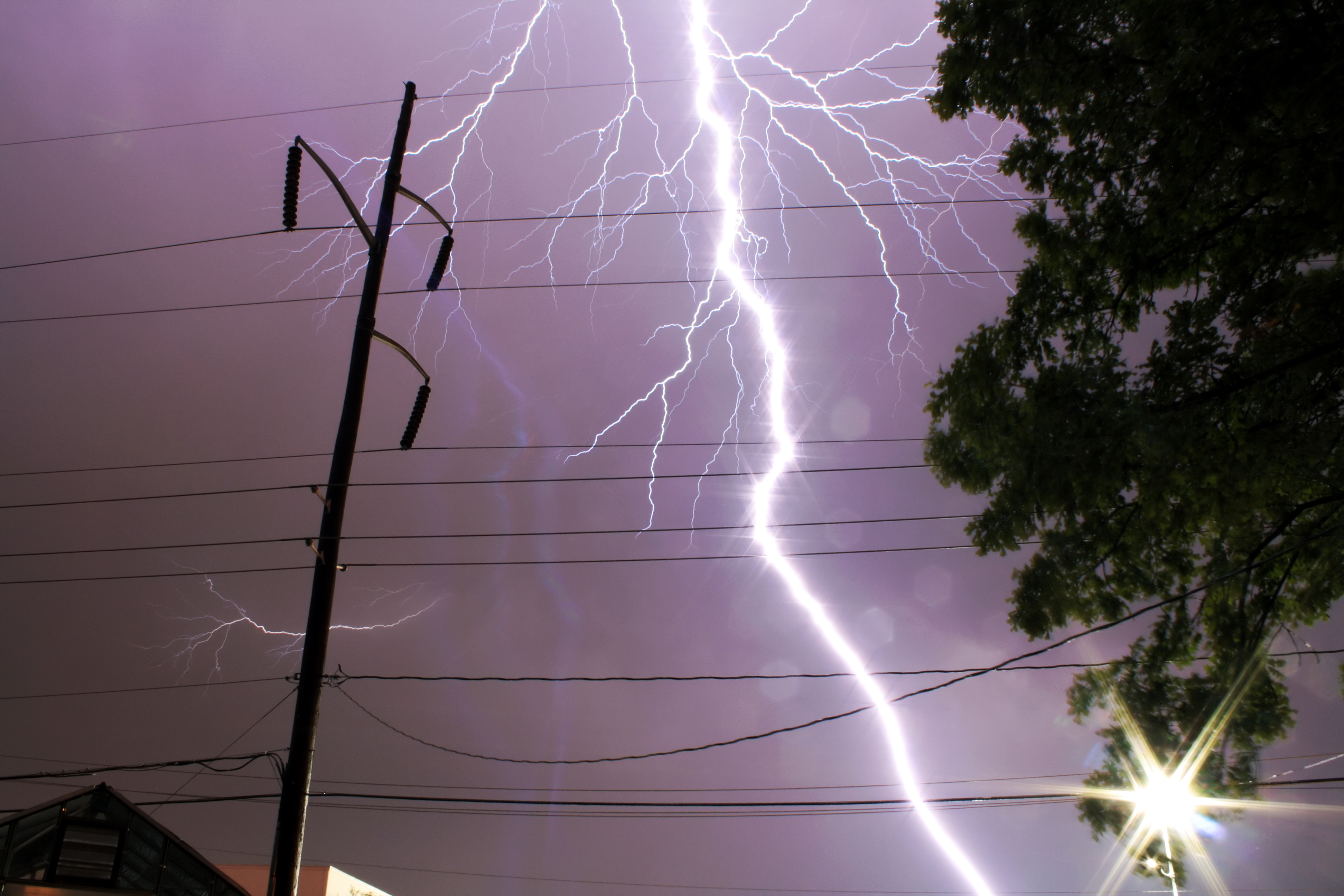 A lightning bolt as seen from about 500 ft. away, a mile north of Pantego, Texas. The lightning was associated with a severe storm that had produced golfball sized hail four miles to the south of this photo. The lightning had struck a tree several blocks eastward. 
Author: Raven Vasquez